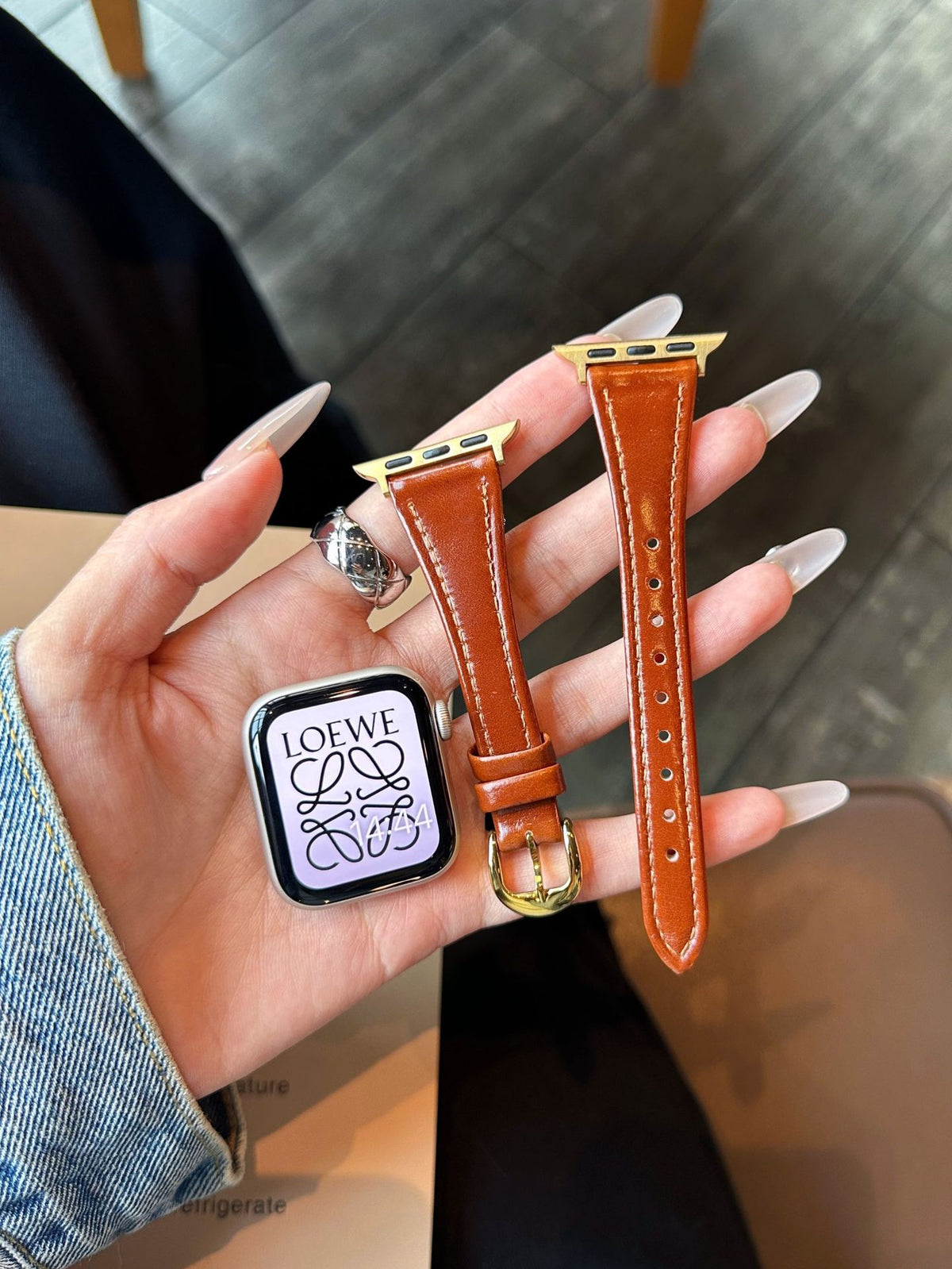 Dark brown leather Apple Watch band with gold-tone buckle