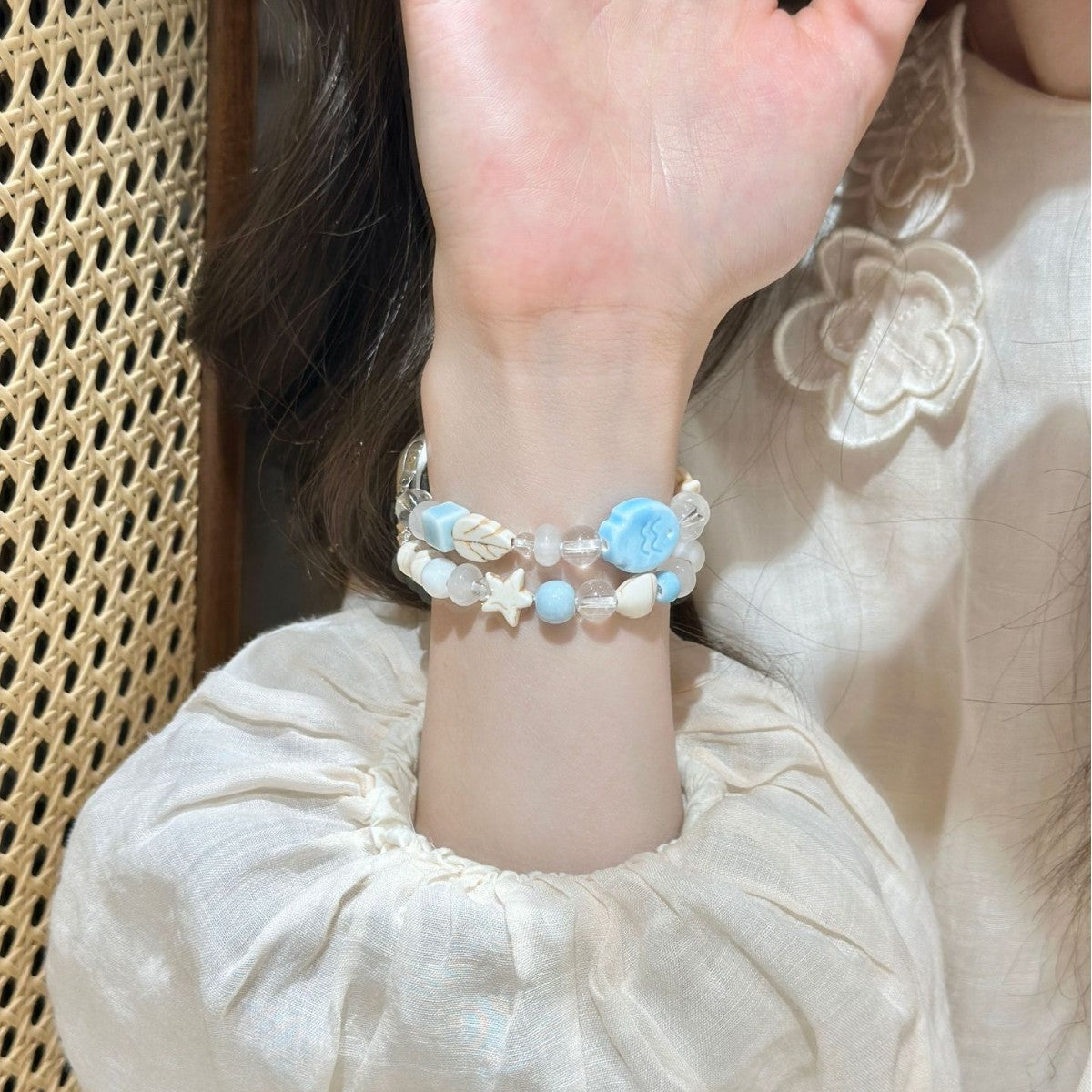 Blue white shell and star smartwatch bracelet band worn on wrist