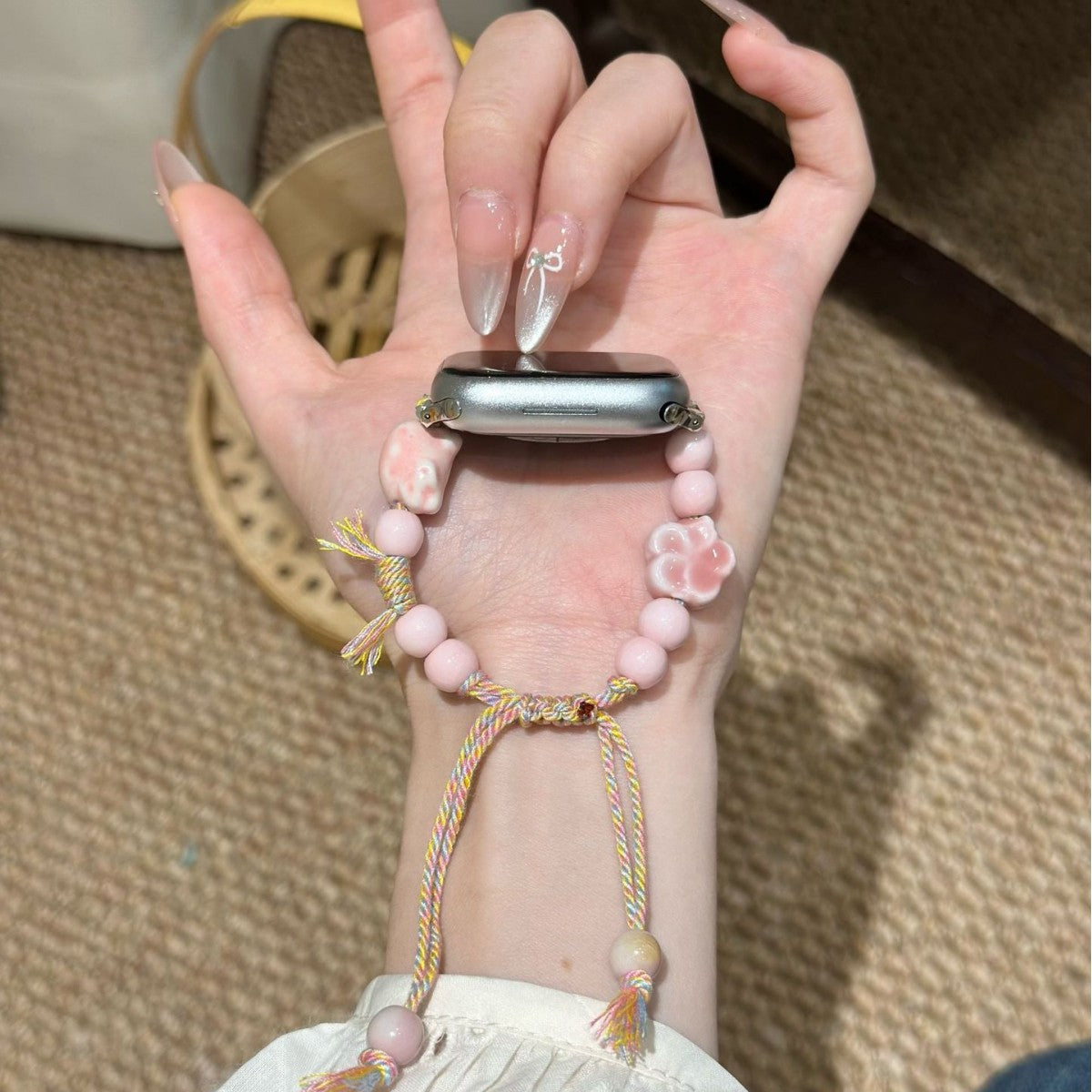Blush pink flower bead Apple Watch band held in hand