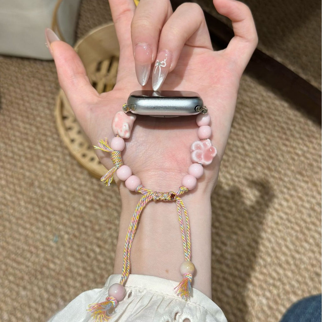 Blush pink beaded Apple Watch band with floral charm and tassel cord