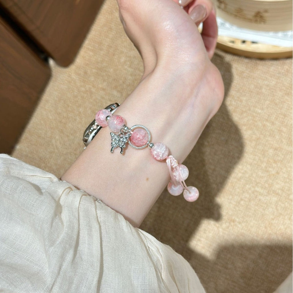 Pink beaded butterfly charm Apple Watch bracelet band side wrist view