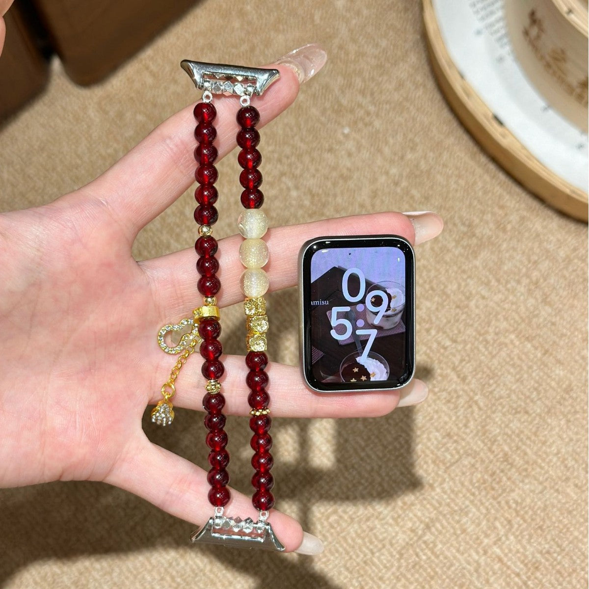 Burgundy and ivory double-strand Apple Watch band display