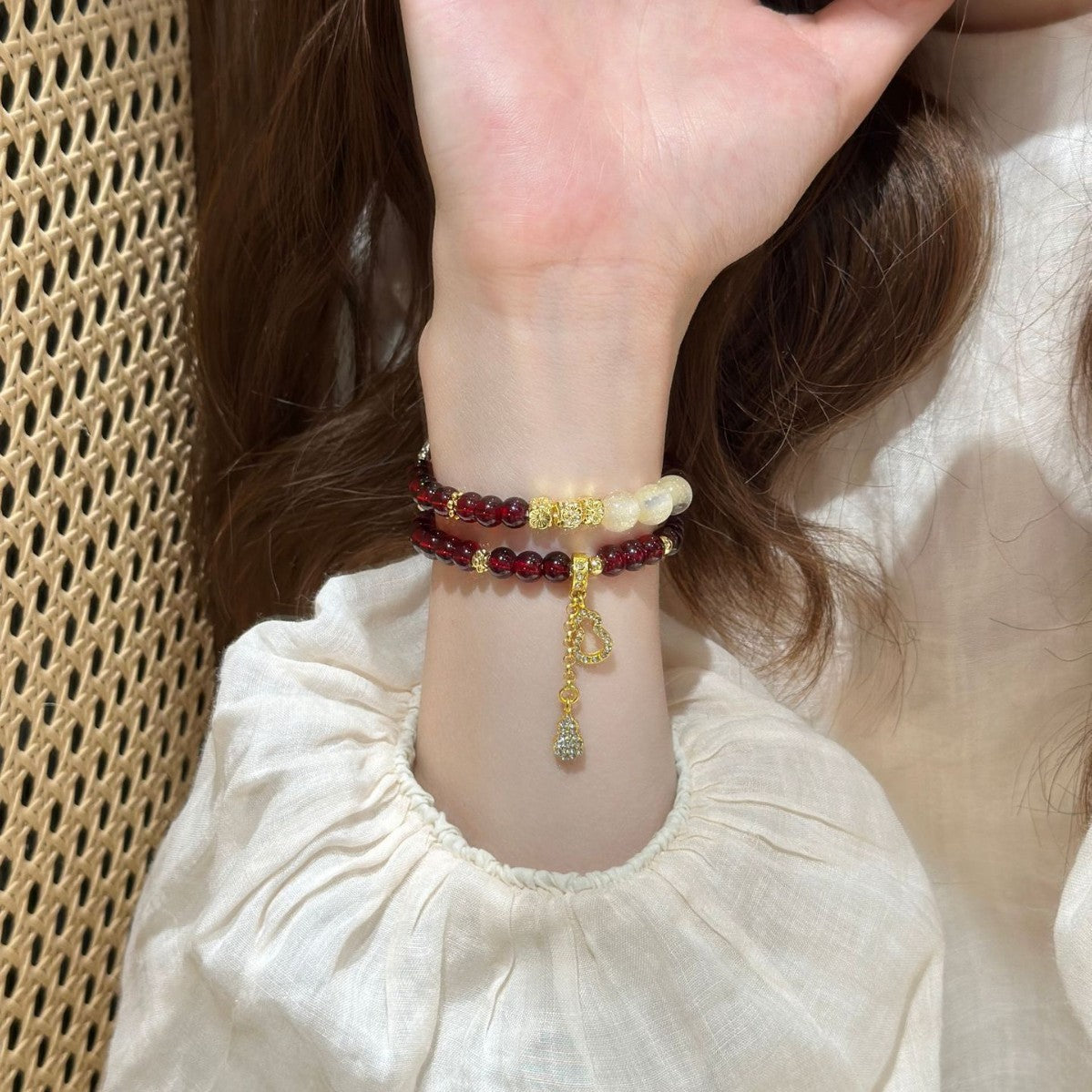 Burgundy and ivory beaded Apple Watch bracelet band worn on wrist