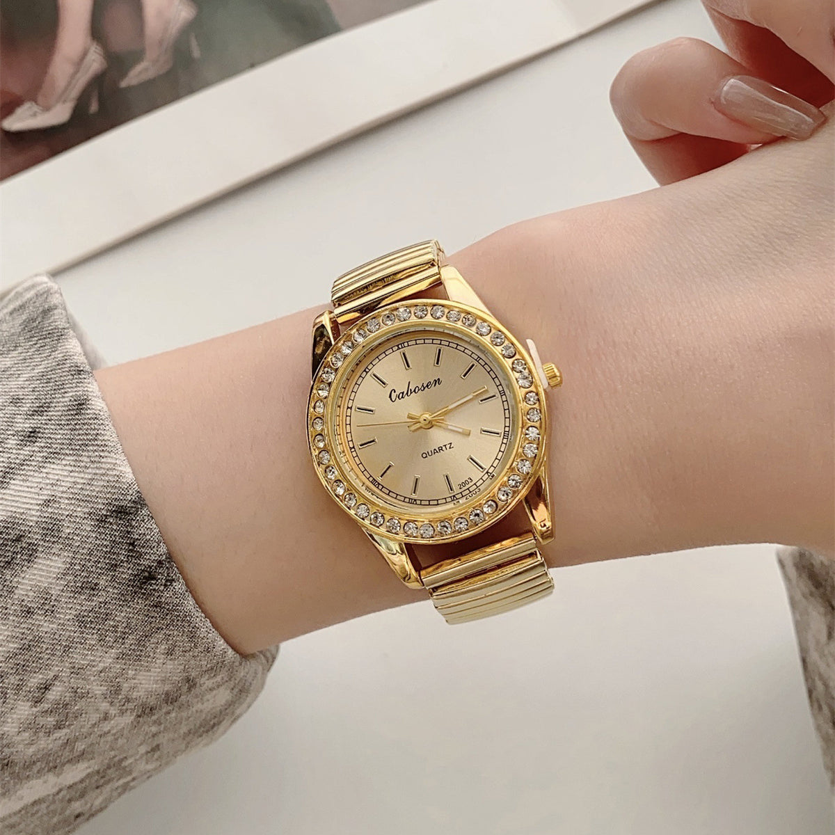 CABOSEN vintage gold-tone stretch bracelet quartz watch with crystal-style bezel on wrist