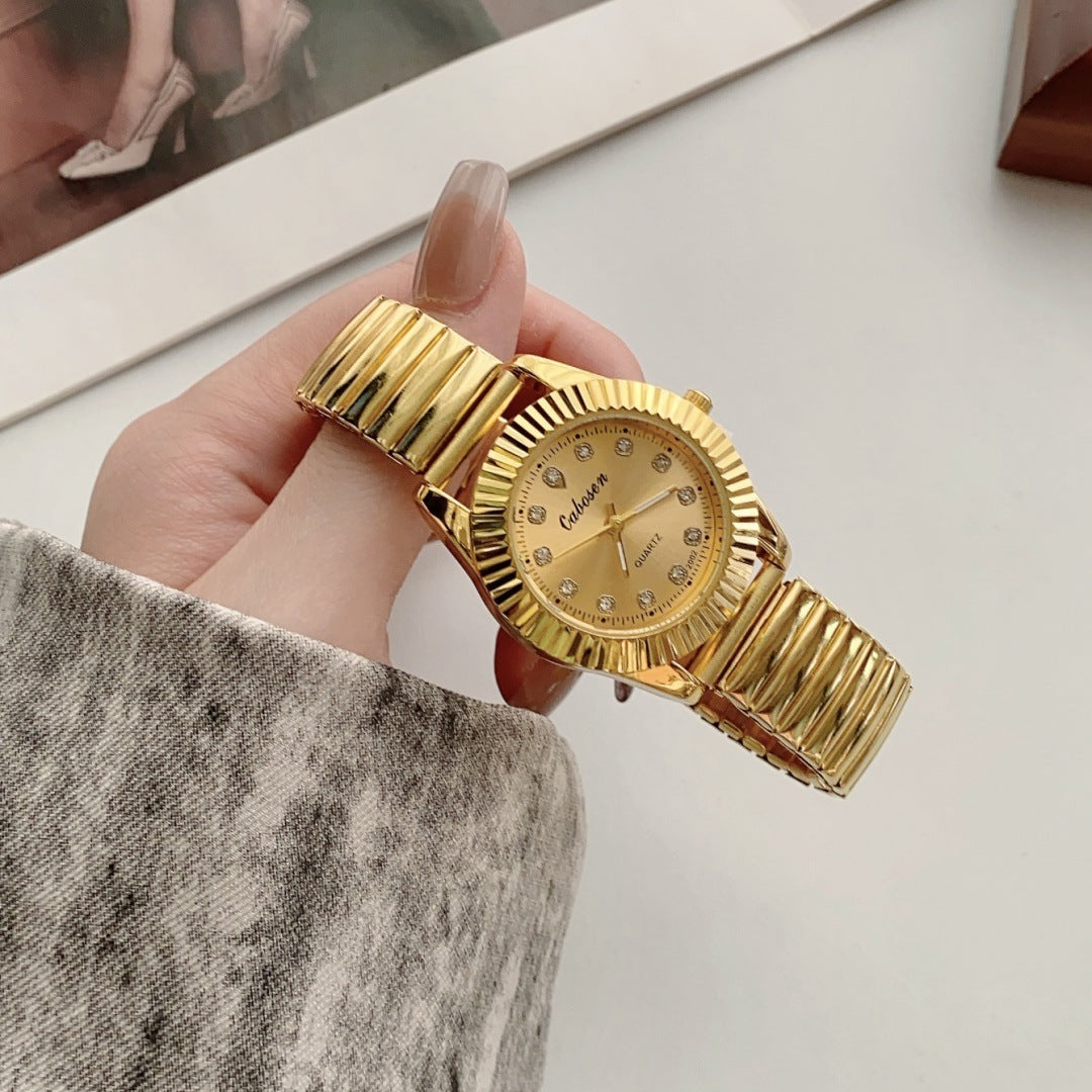 CABOSEN gold-tone stretch bracelet quartz watch with fluted bezel and crystal-style hour markers