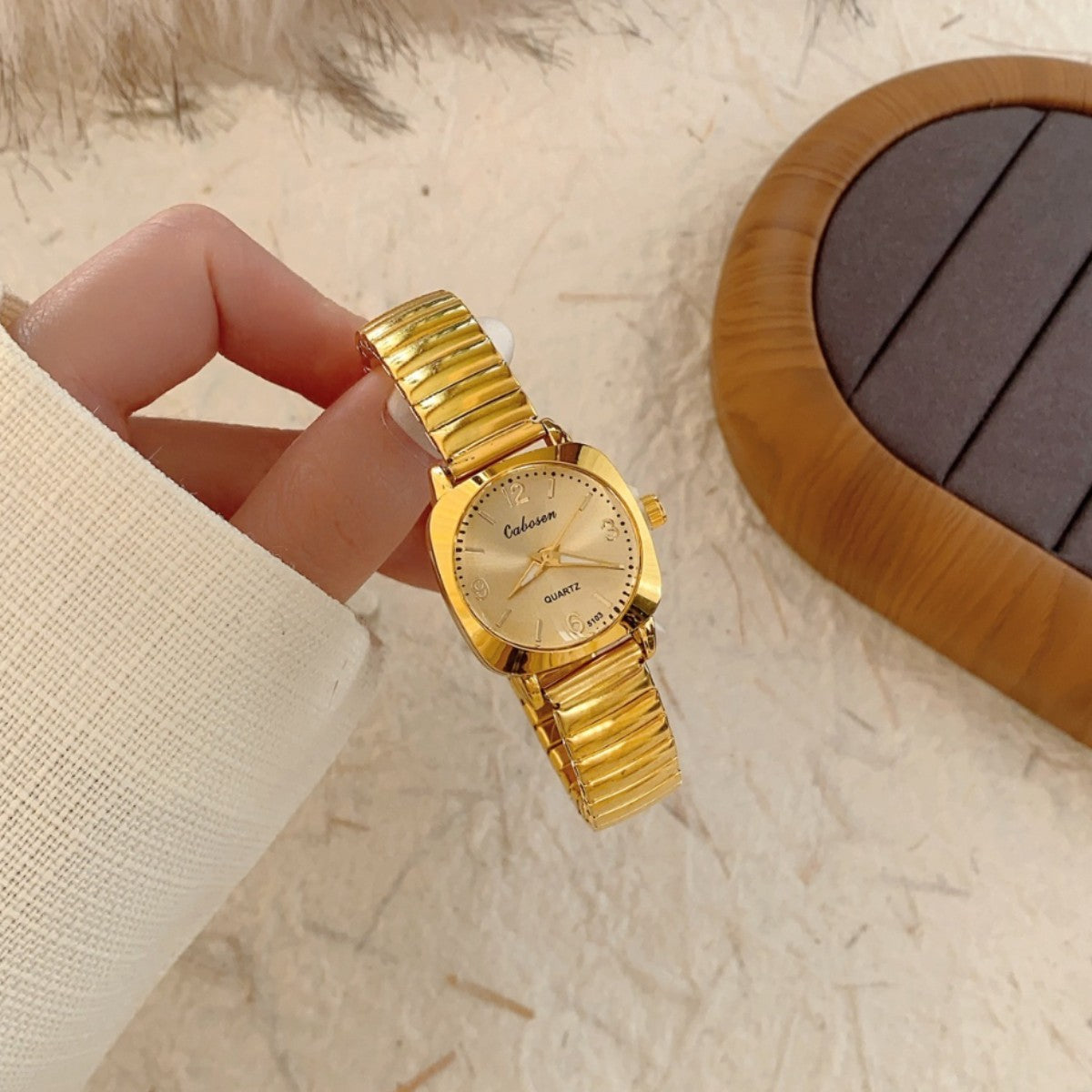 CABOSEN vintage small women's watch with gold-tone stretch bracelet and champagne dial close-up