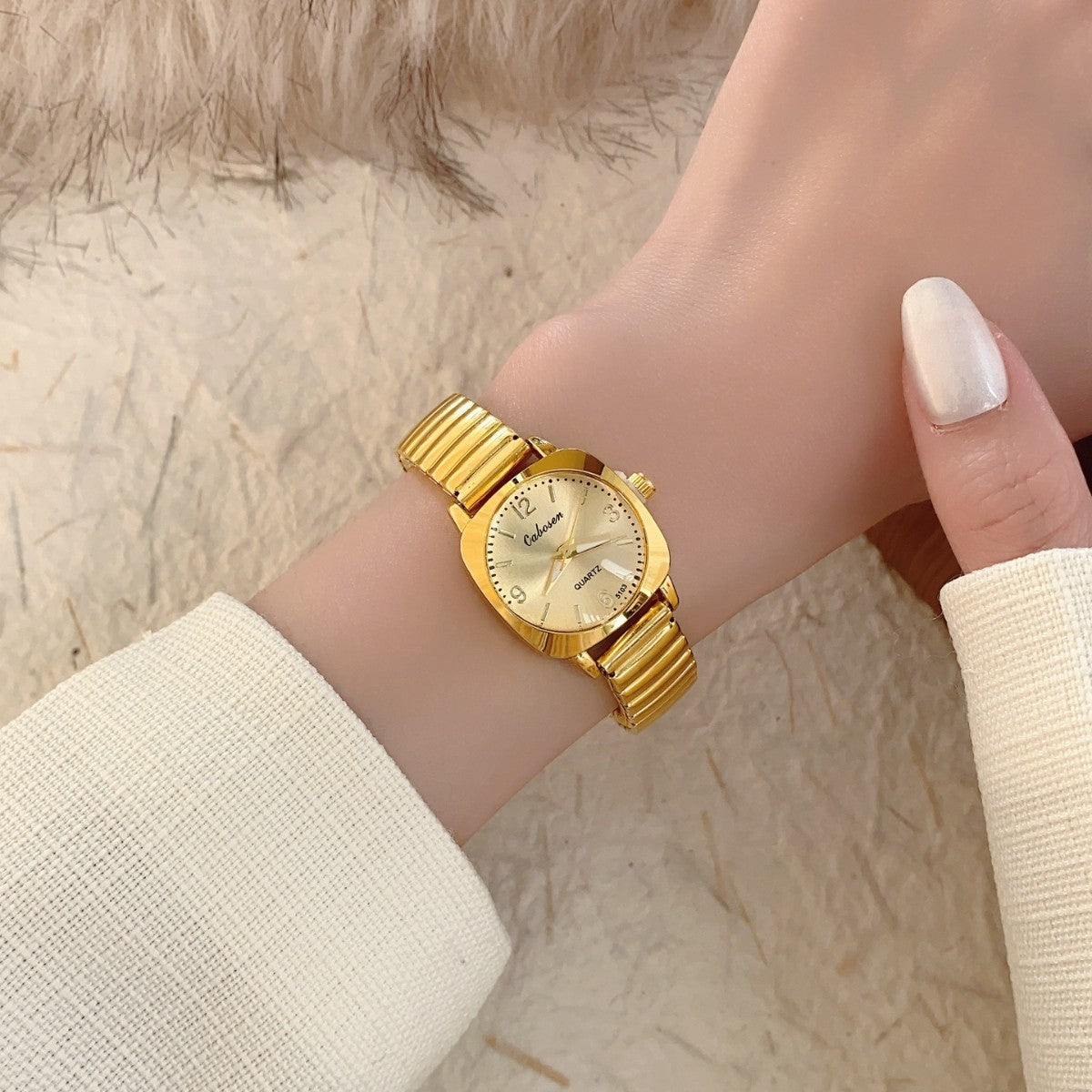 CABOSEN vintage small women's watch with gold-tone stretch bracelet styled on wrist