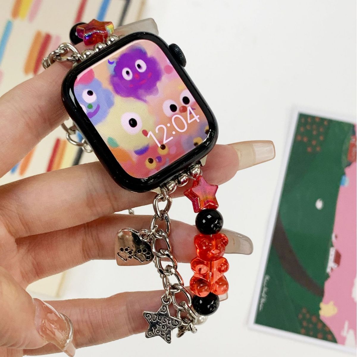Pink red gummy bear charm Apple Watch band close-up