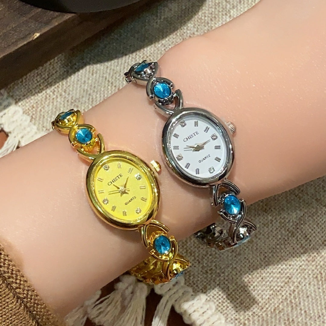 CHISTE blue cabochon-style bracelet watch in gold tone with yellow dial