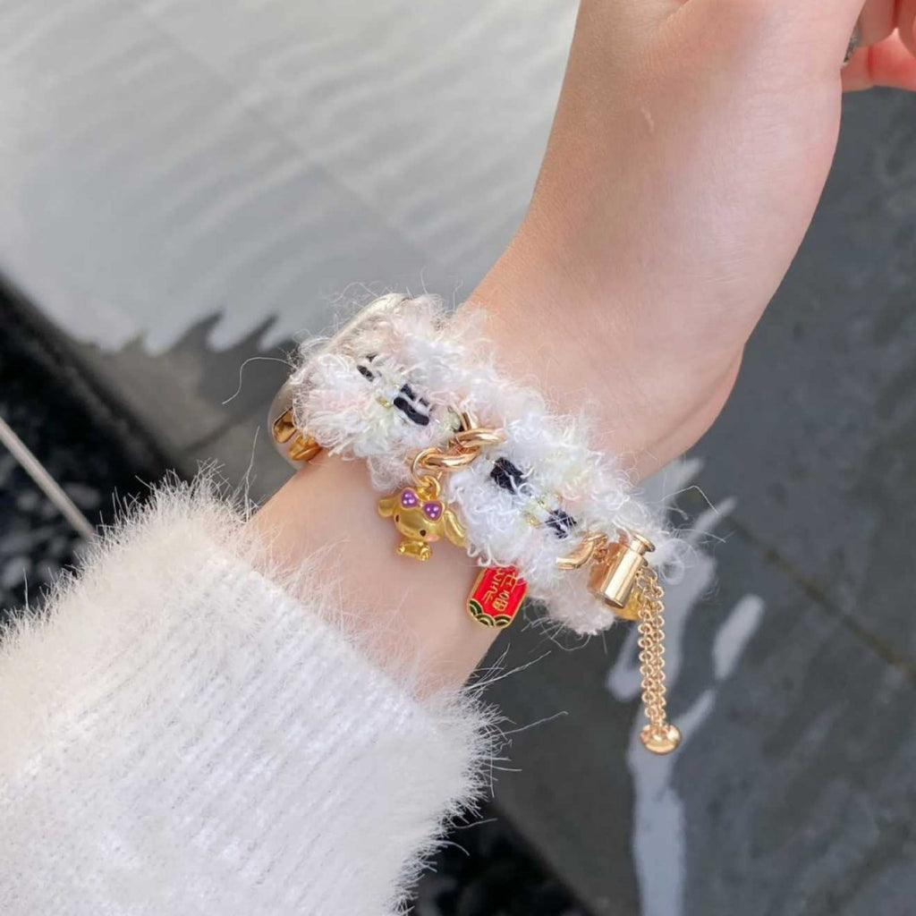 White fuzzy charm Apple Watch band worn on wrist
