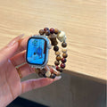 Brown rose double-strand Apple Watch bracelet band held in hand