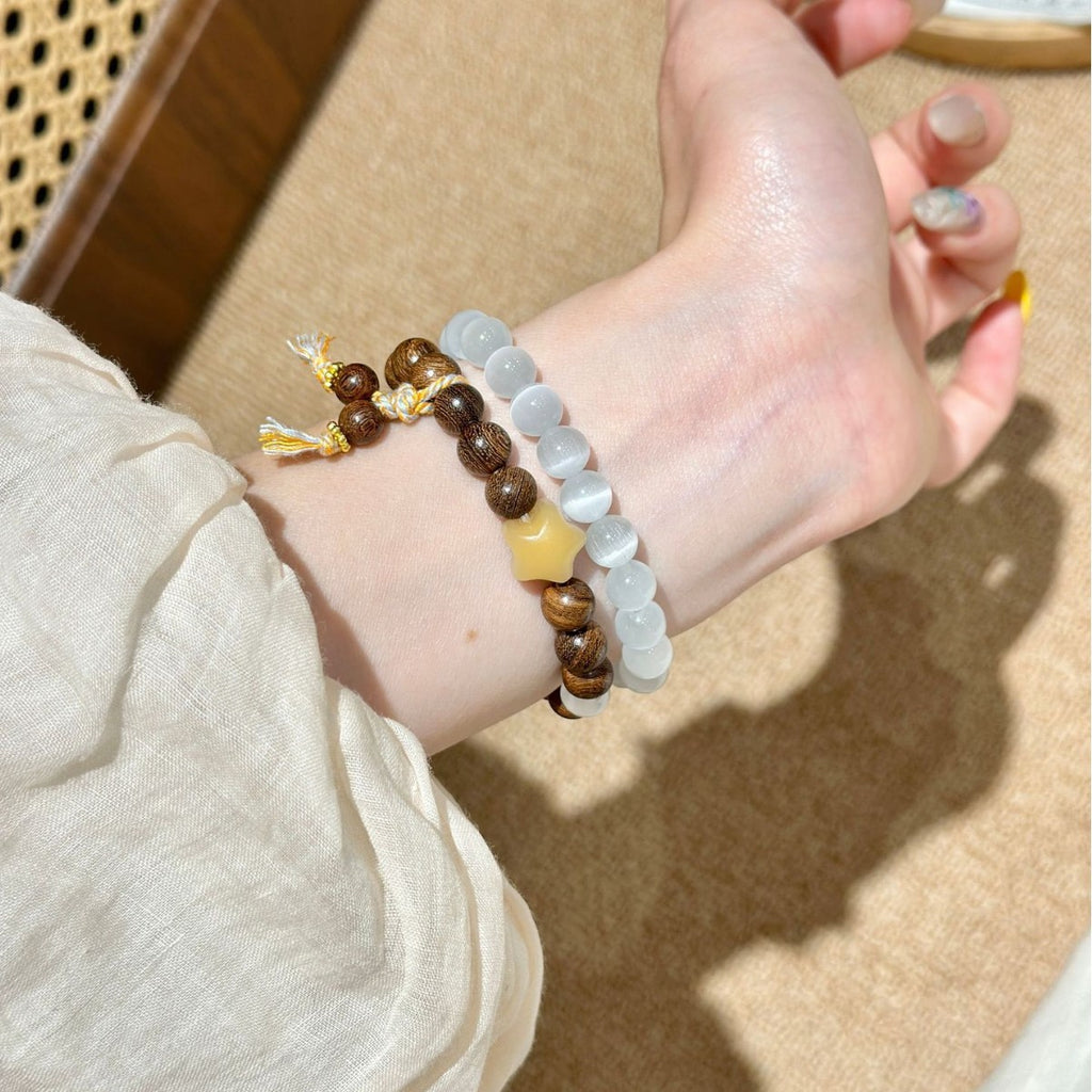 Brown and milky white double-strand Apple Watch bracelet band side wrist view