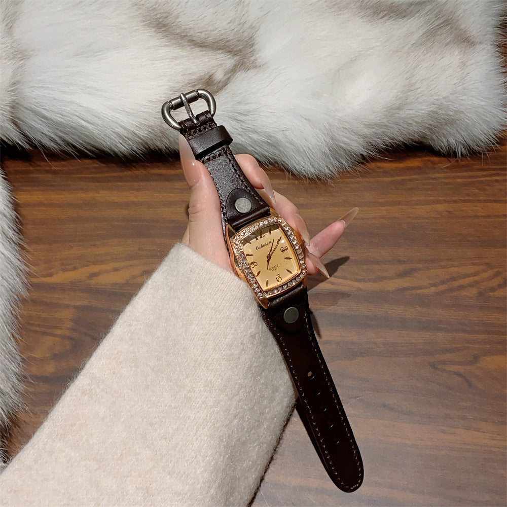 Vintage crystal tonneau women's watch with black leather strap and champagne dial