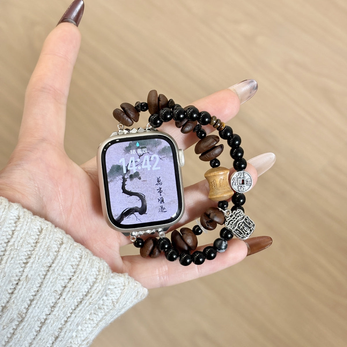 Black and brown double-strand jewellery Apple Watch band with coffee-bean style beads and silver-tone charms