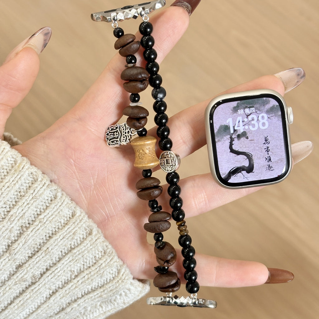 Espresso brown and black double-strand Apple Watch band held in hand
