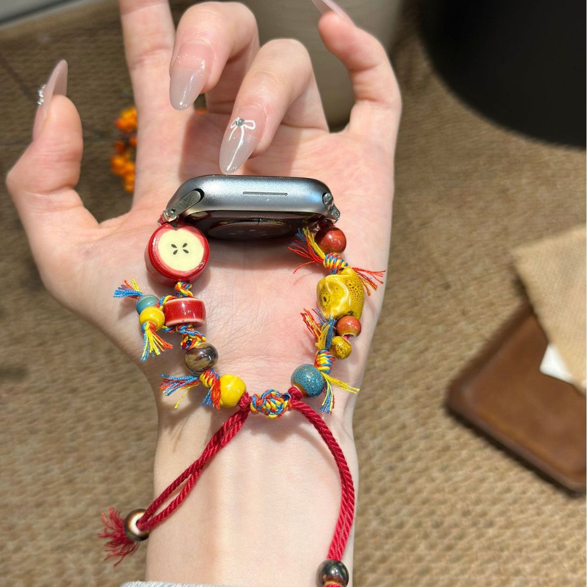 Red cord colorful apple charm Apple Watch bracelet band front view