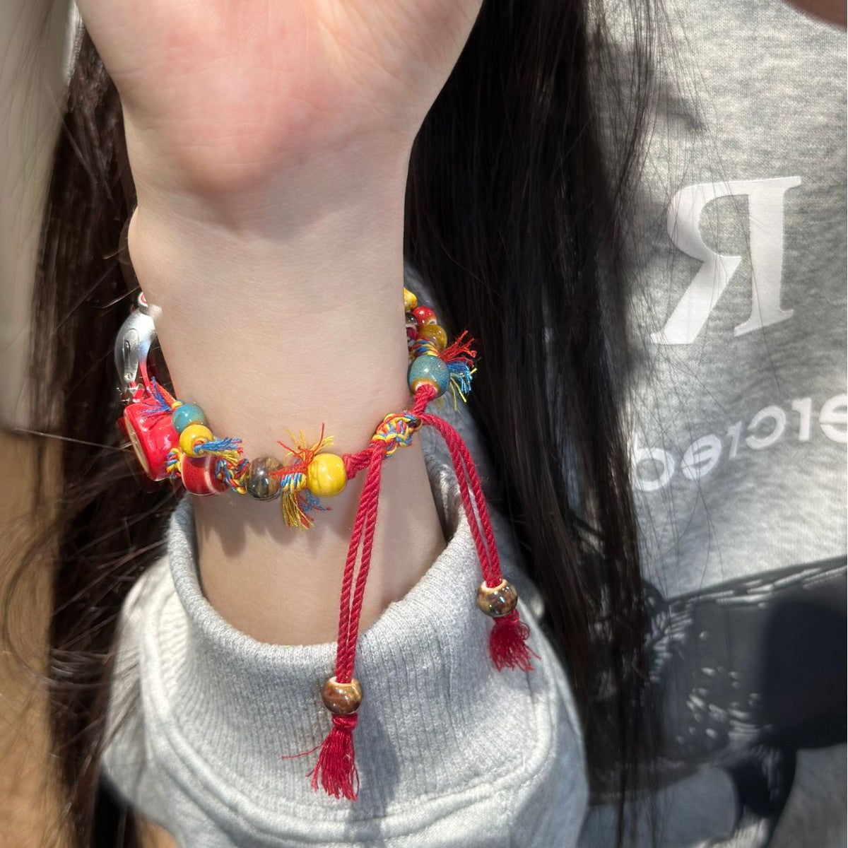 Colorful red cord apple charm Apple Watch bracelet band worn on wrist