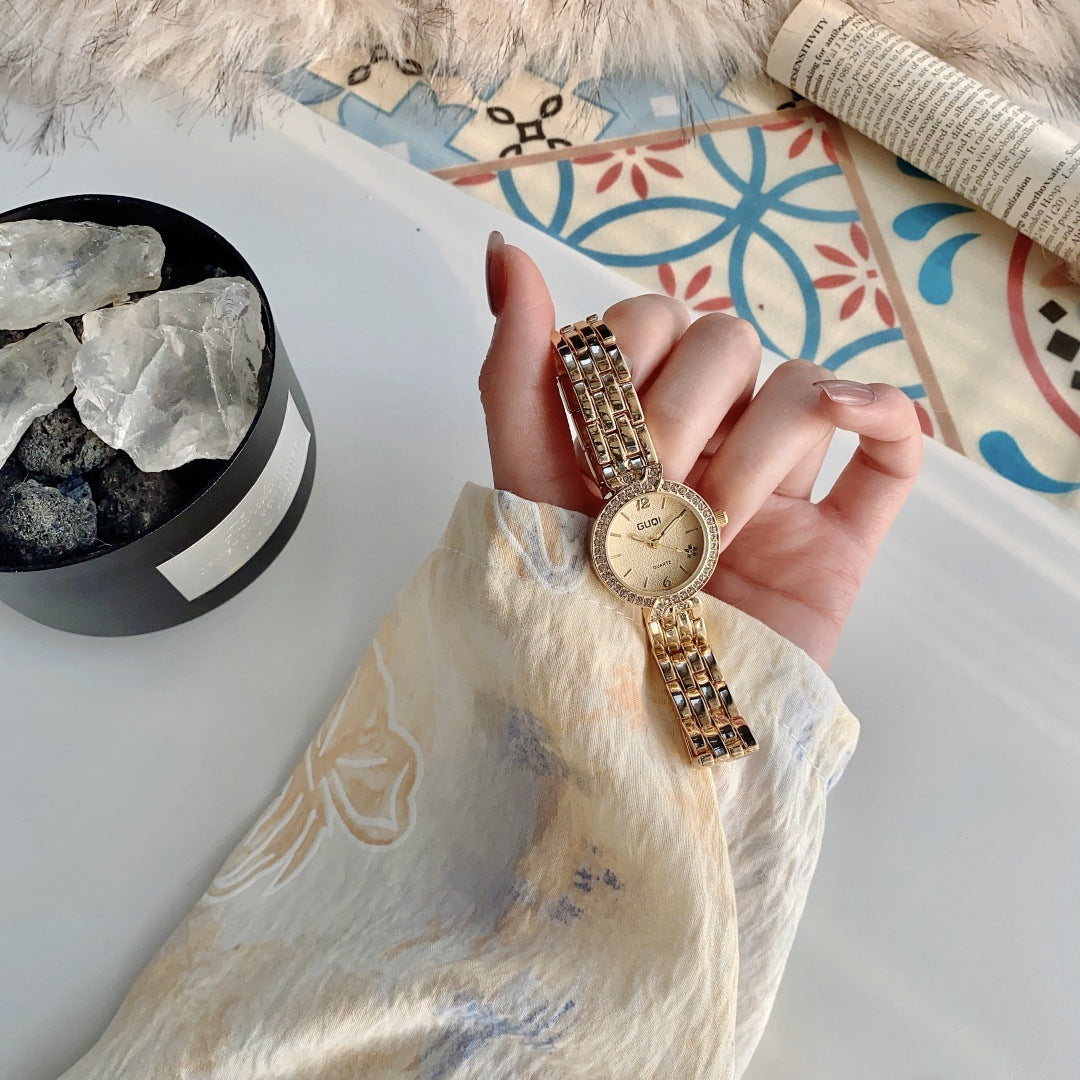 GUDI crystal-style bezel round bracelet watch in gold tone with champagne dial