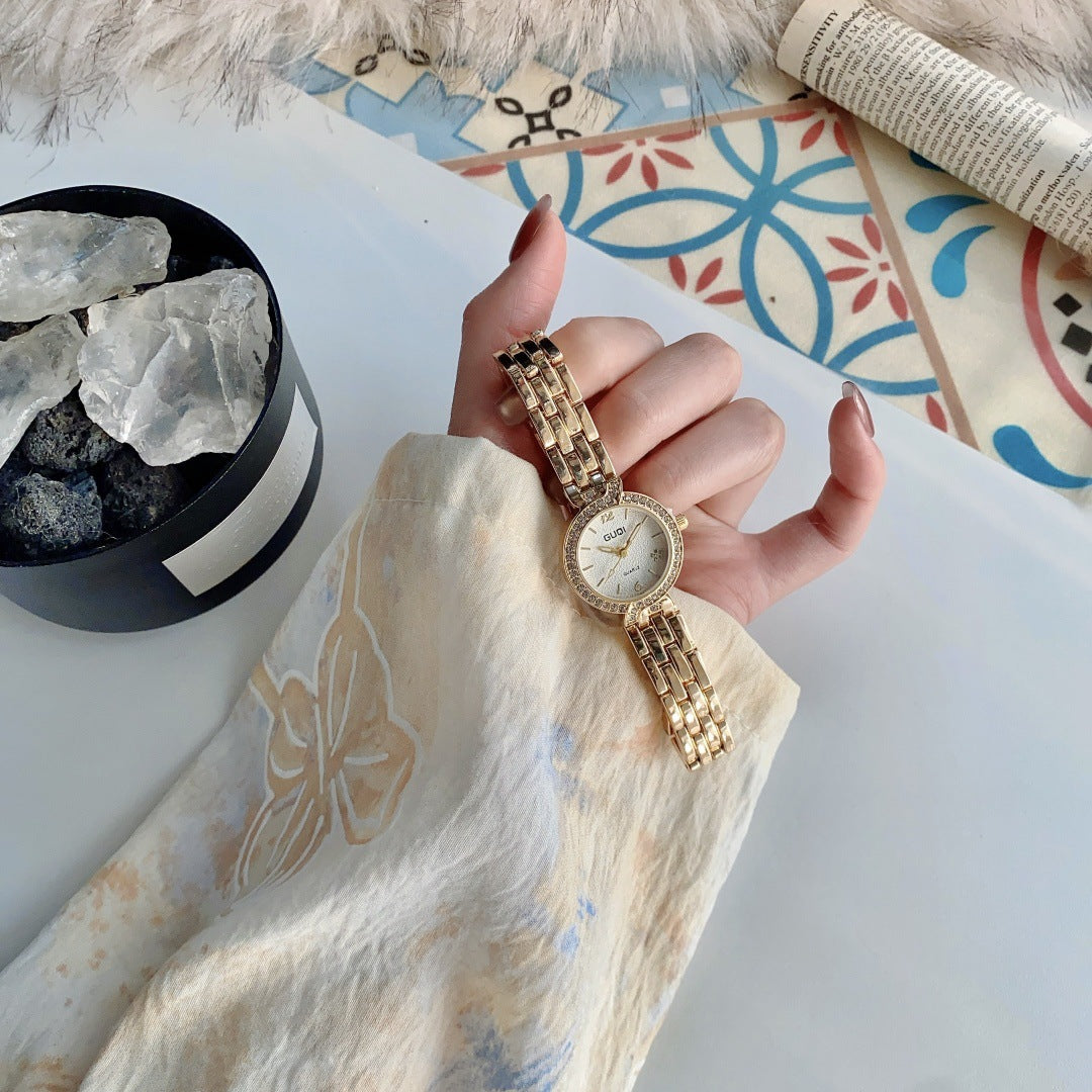 GUDI crystal-style bezel round bracelet watch in gold tone with white dial