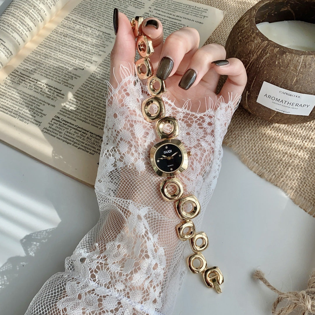 GUDI open-link round jewelry watch in gold tone with black dial full view