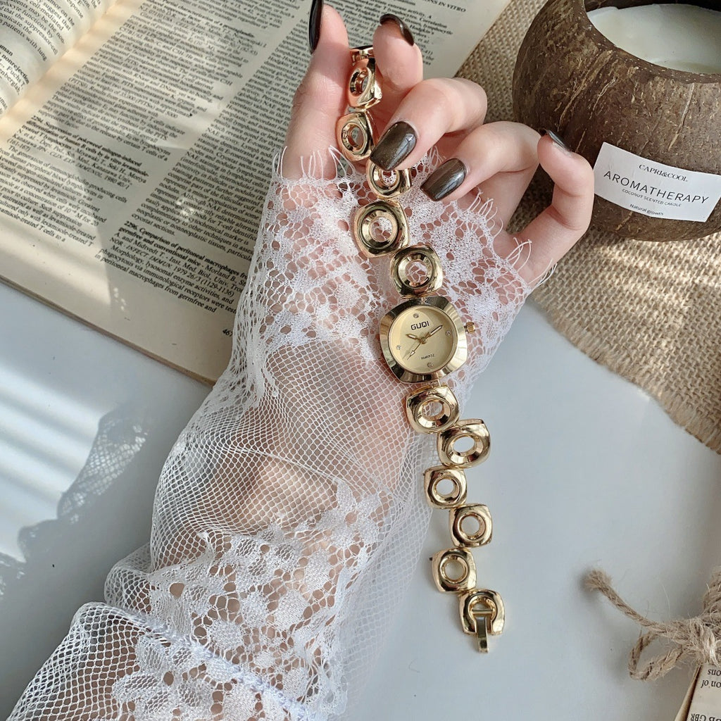 GUDI open-link round jewelry watch in gold tone with champagne dial full view
