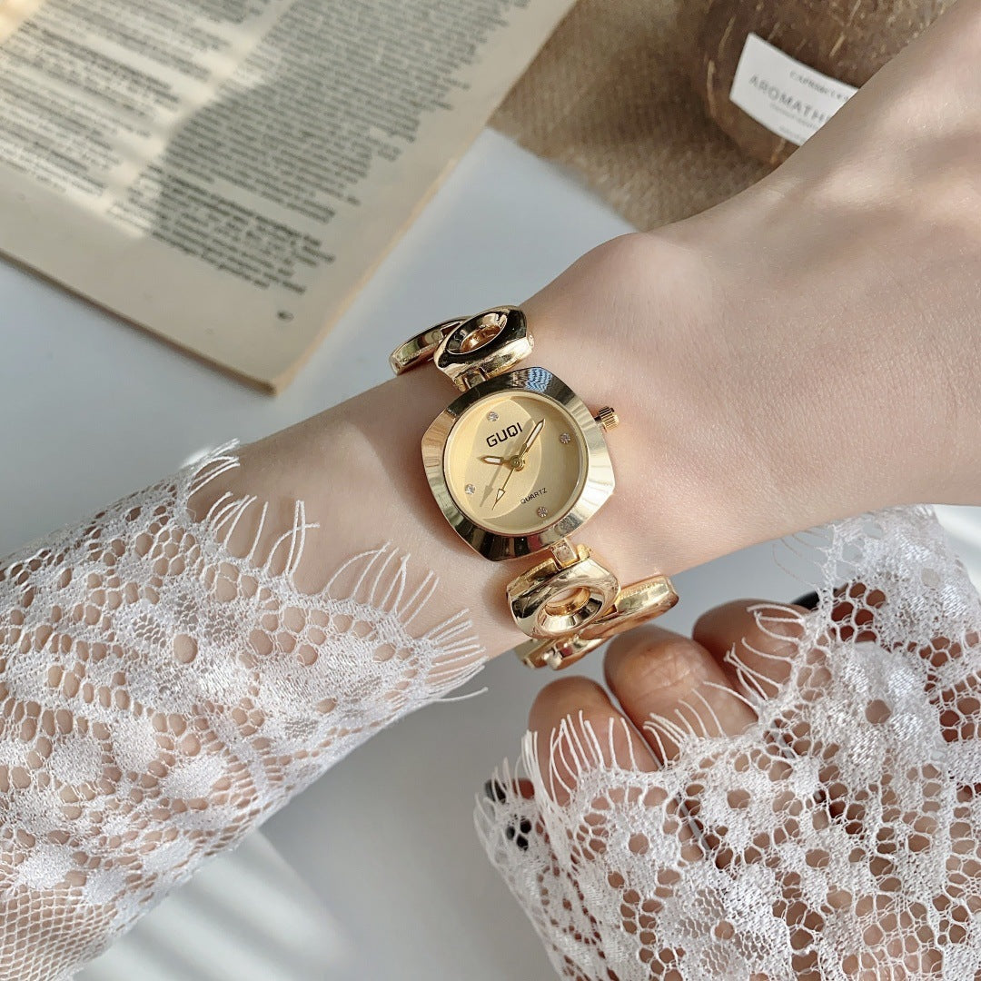 GUDI open-link round jewelry watch in gold tone with champagne dial
