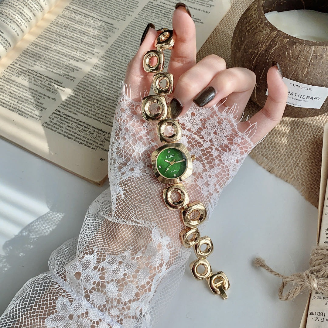 GUDI open-link round jewelry watch in gold tone with green dial full view