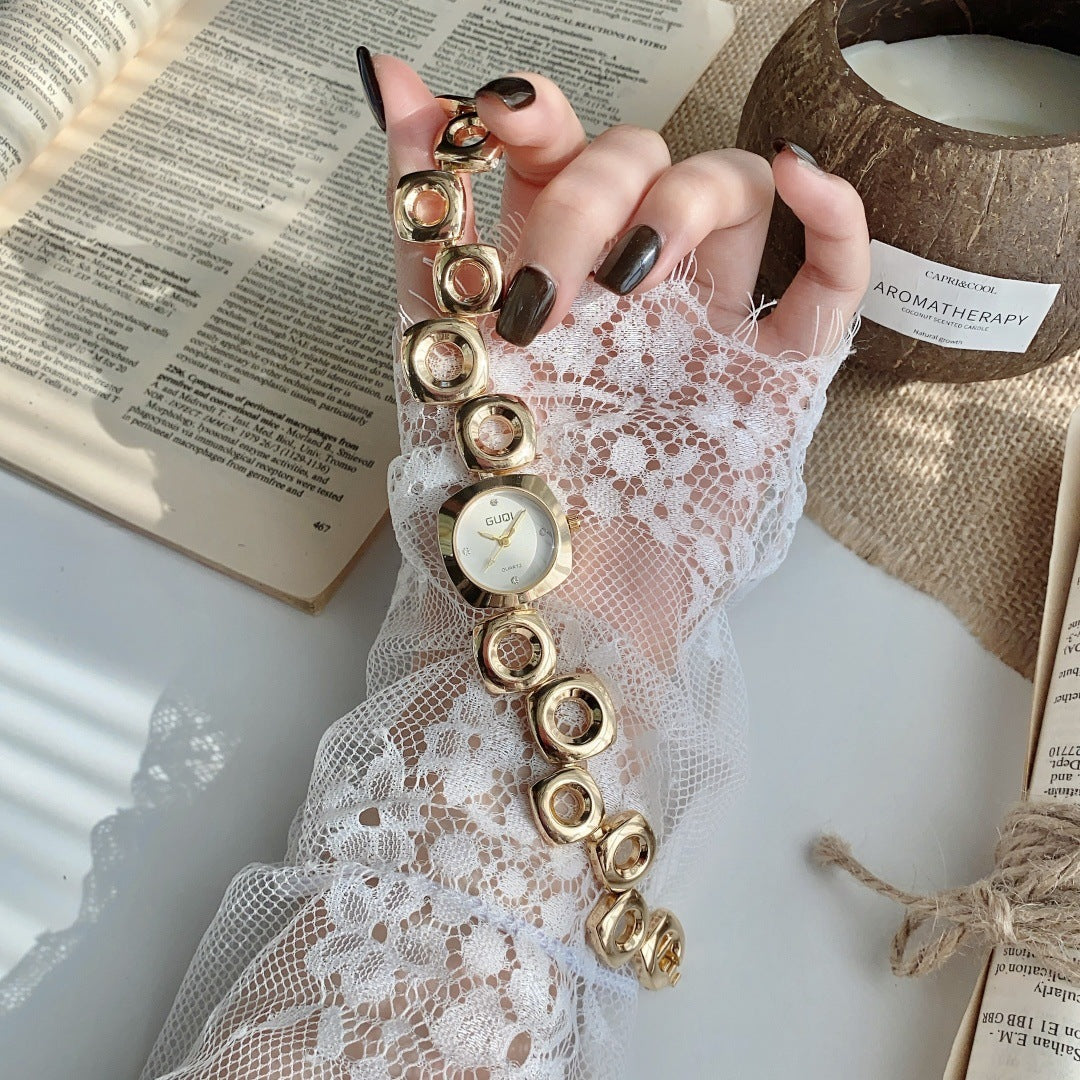 GUDI open-link round jewelry watch in gold tone with white dial full view