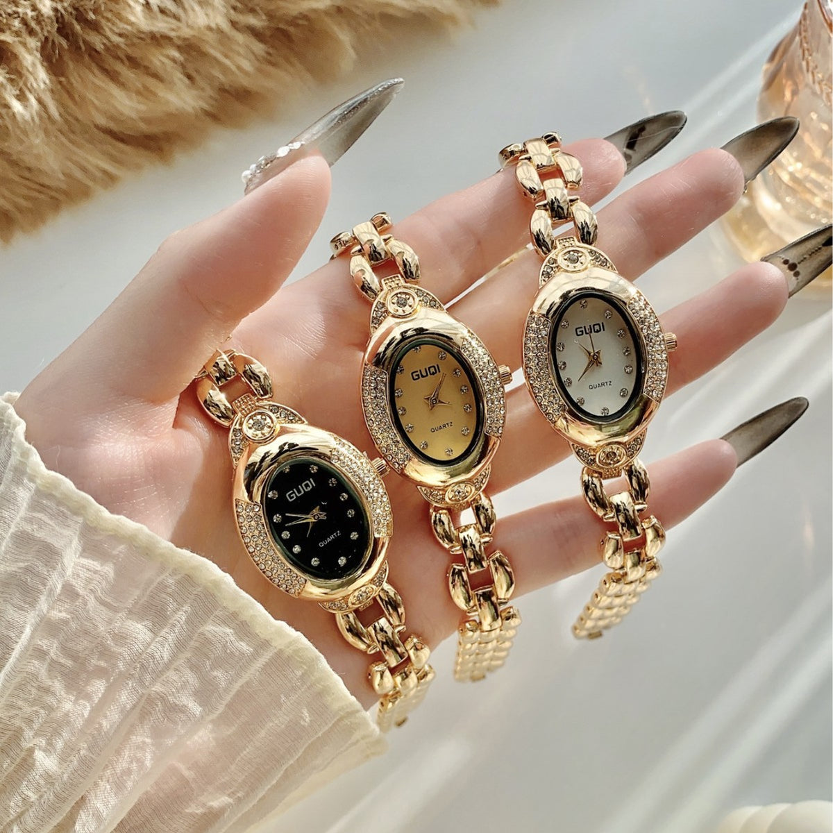 GUDI oval crystal-style jewelry watches with sculpted link bracelets in black champagne and white dials