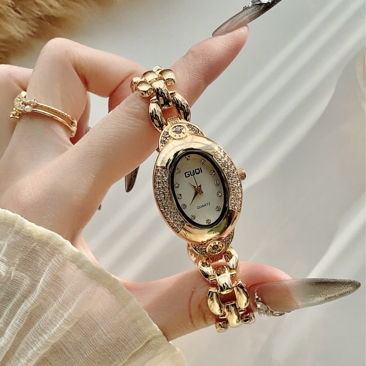GUDI oval crystal-style jewelry watch with sculpted link bracelet and white dial