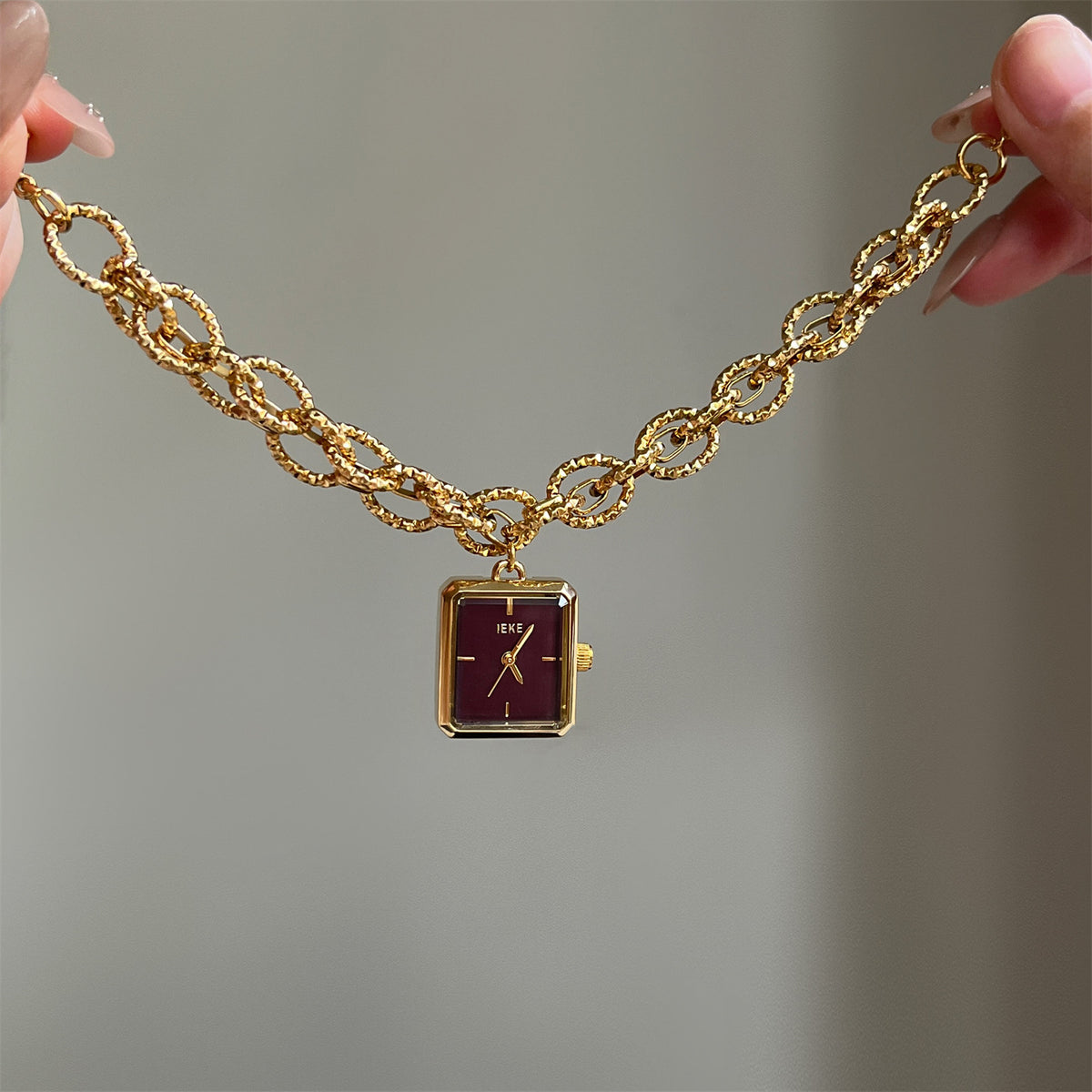 IEKE gold-tone chain bracelet watch with burgundy dial