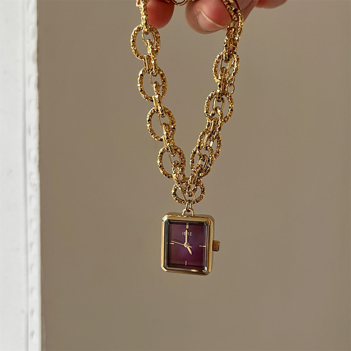IEKE gold-tone chain bracelet watch with plum dial
