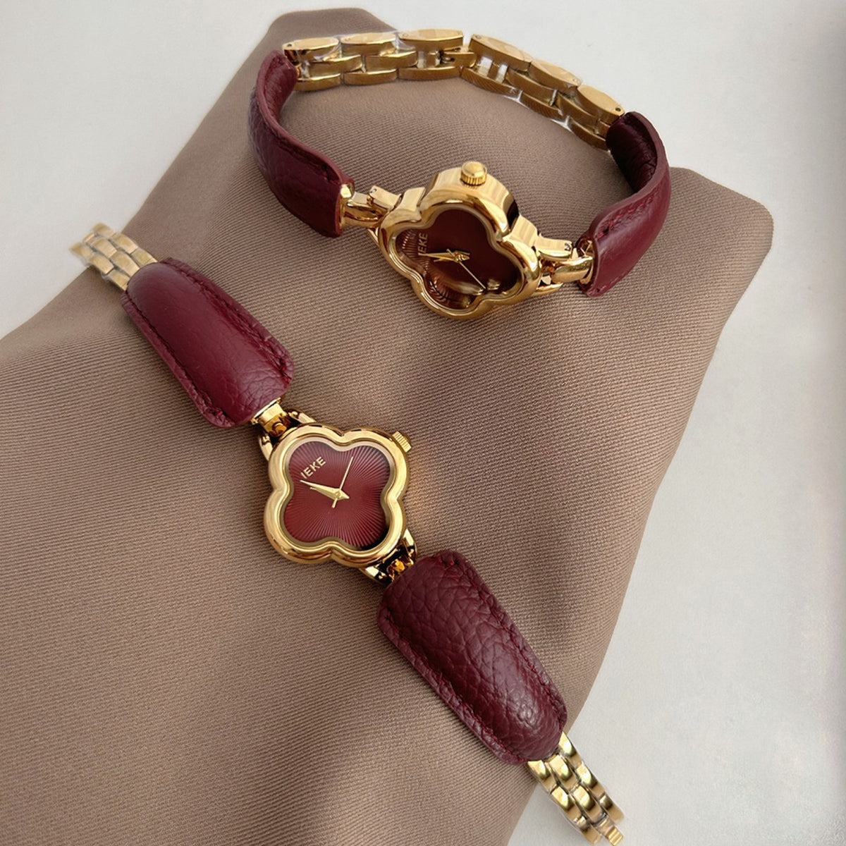 IEKE clover-shaped women's watch in gold with burgundy dial and burgundy leather accents