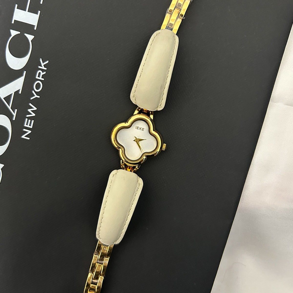 IEKE clover-shaped women's watch in gold with ivory dial and cream leather accents
