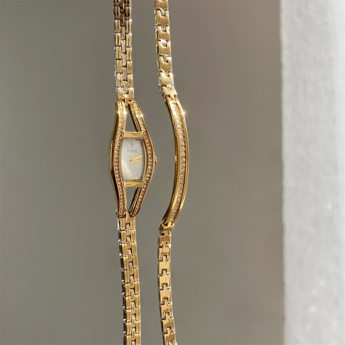 IEKE women's crystal bracelet watch in gold tone with white dial