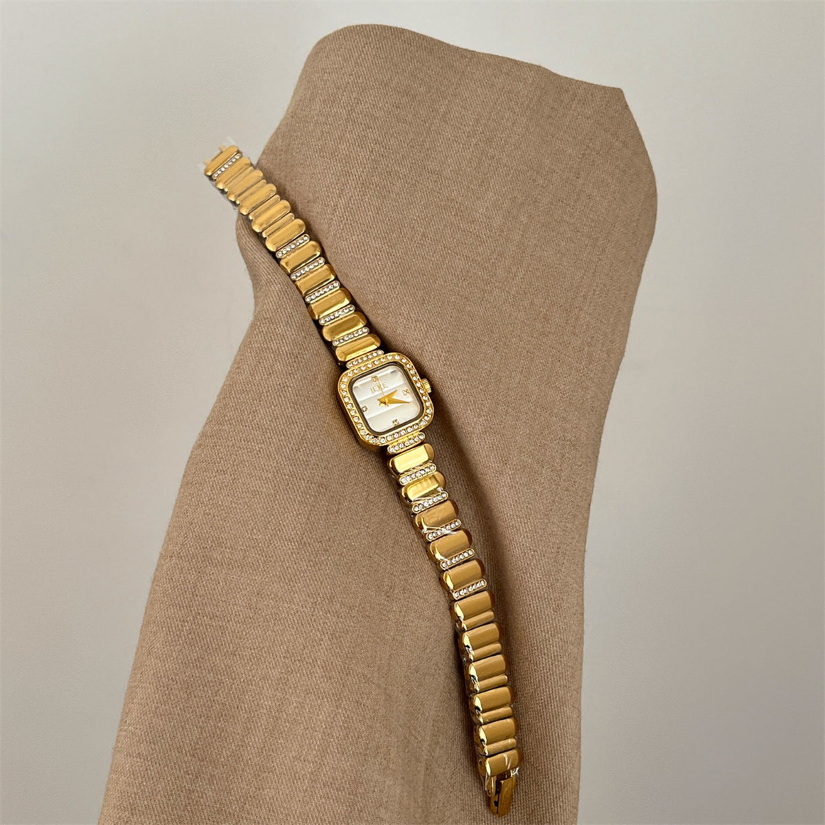 Full bracelet view of IEKE women's crystal square watch in gold with champagne dial