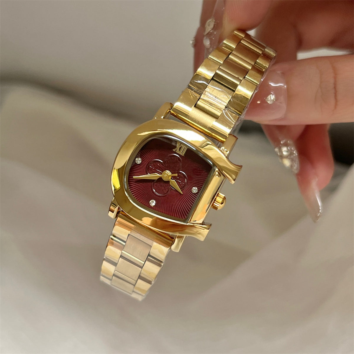 IEKE women's D-shape floral quartz watch in gold tone with burgundy dial and steel bracelet