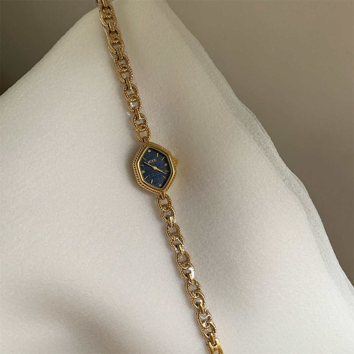 IEKE diamond-shaped textured chain bracelet watch with gold-tone bracelet and blue dial