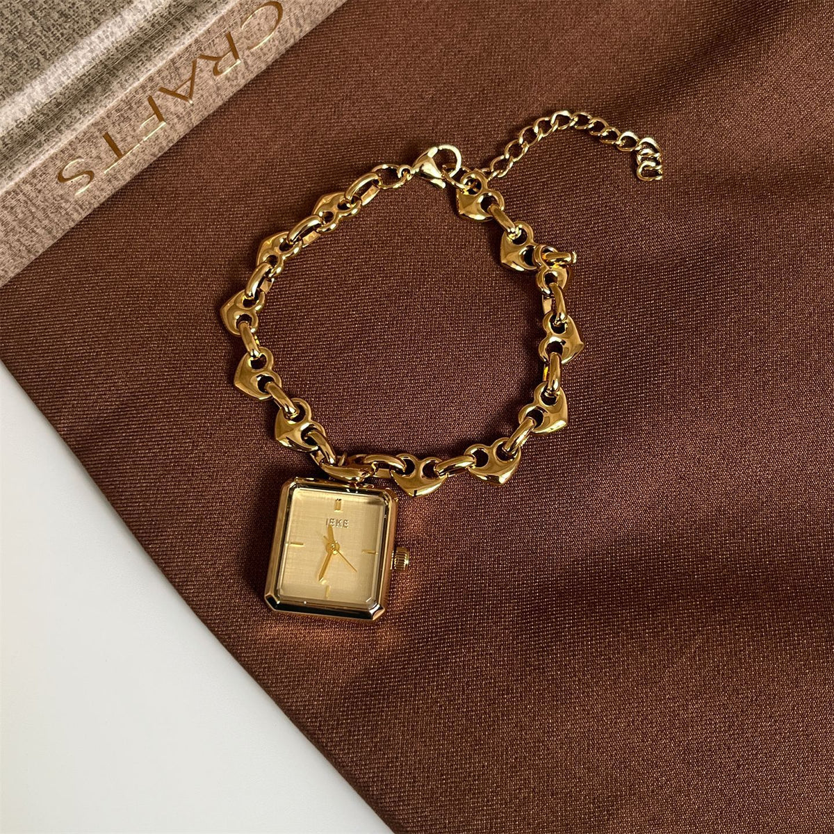 IEKE gold-tone heart-link bracelet watch with champagne dial