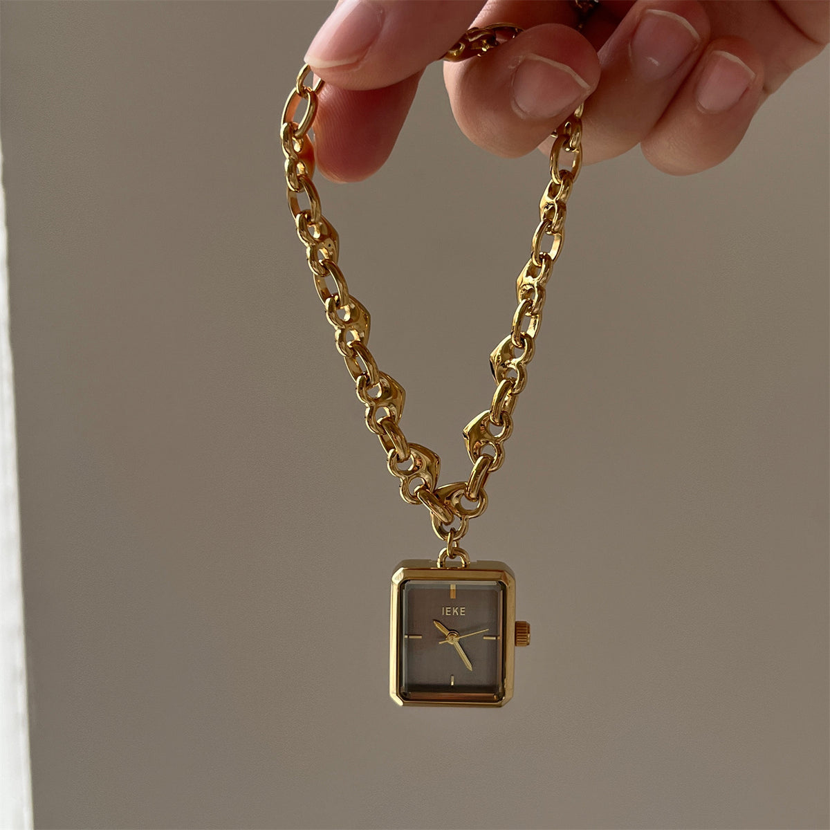 IEKE gold-tone heart-link bracelet watch with smoke grey dial