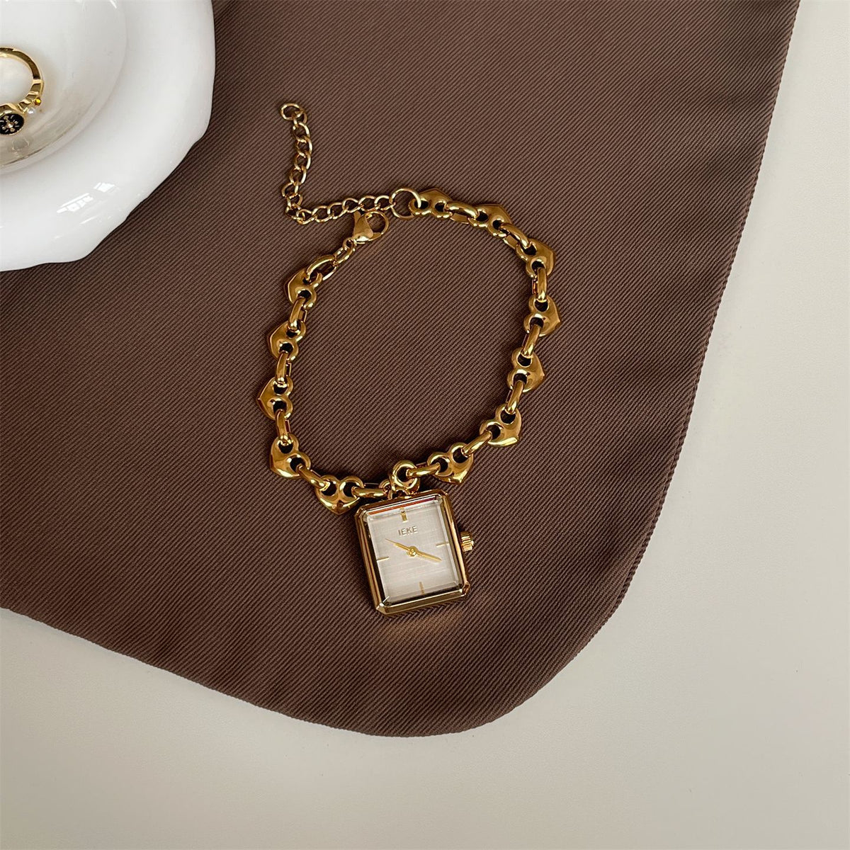IEKE gold-tone heart-link bracelet watch with white dial