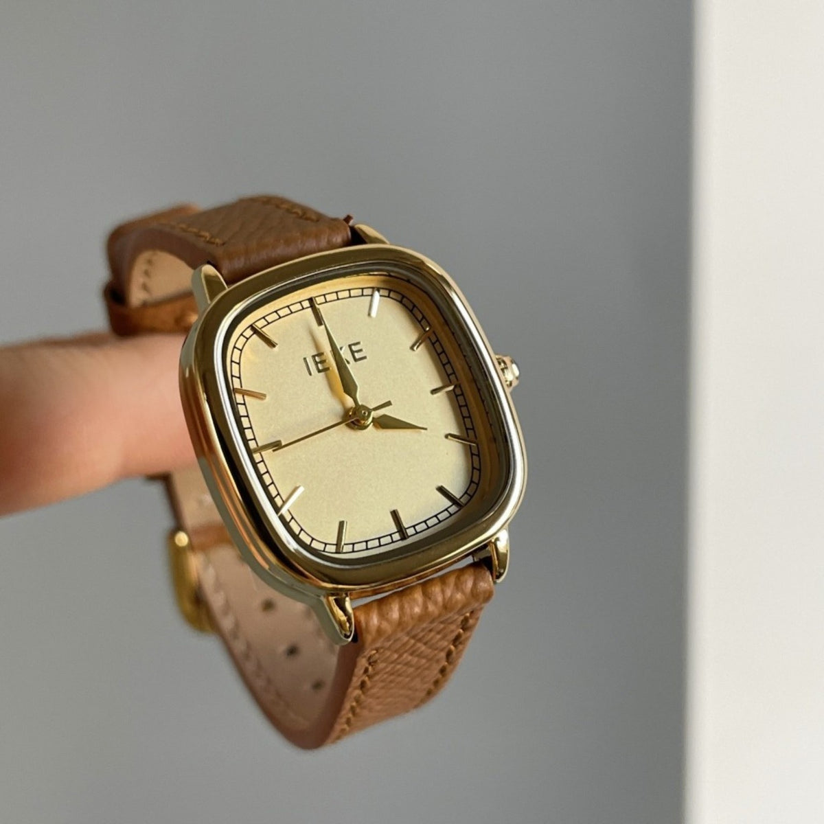 IEKE minimalist cushion-shaped women's watch with gold-tone dial and brown strap