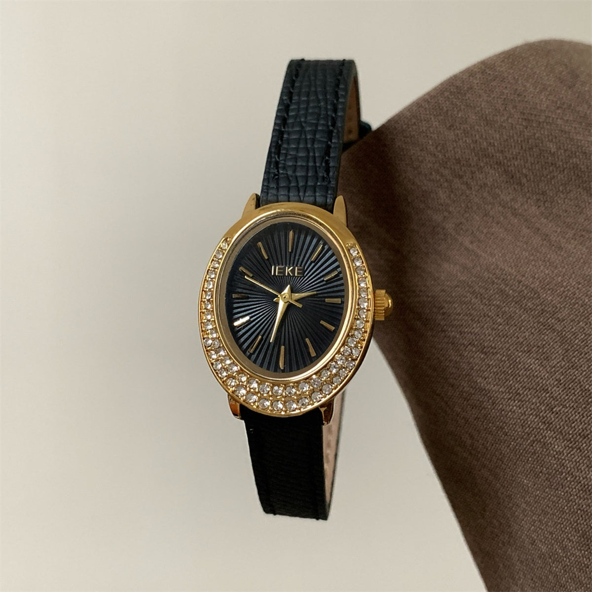 IEKE women's oval crystal watch with black strap, gold case and black dial