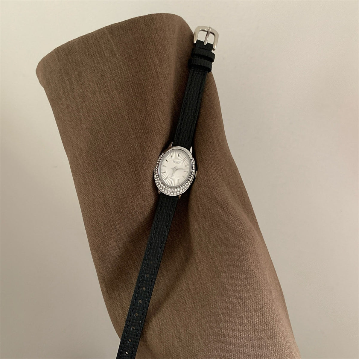 IEKE women's oval crystal watch with black strap, silver case and white dial
