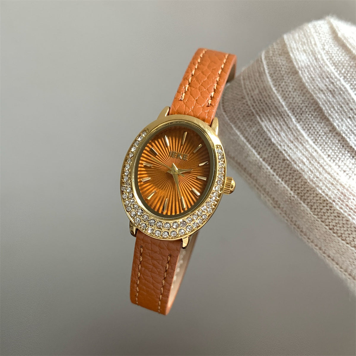 IEKE women's oval crystal watch with orange strap, gold case and orange dial