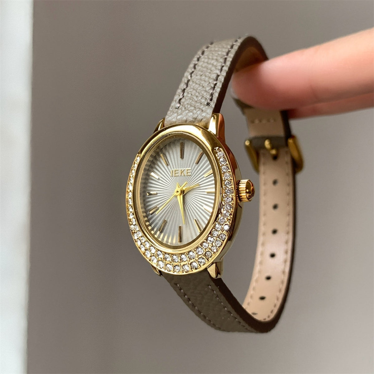 IEKE women's oval crystal watch with taupe strap, gold case and white dial