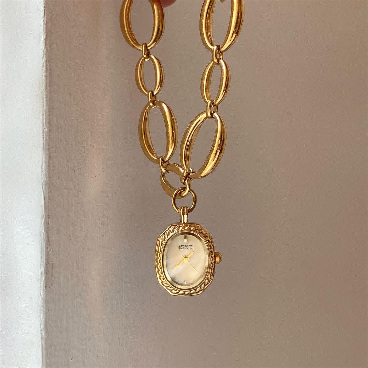 IEKE gold-tone oval-link bracelet watch with champagne dial