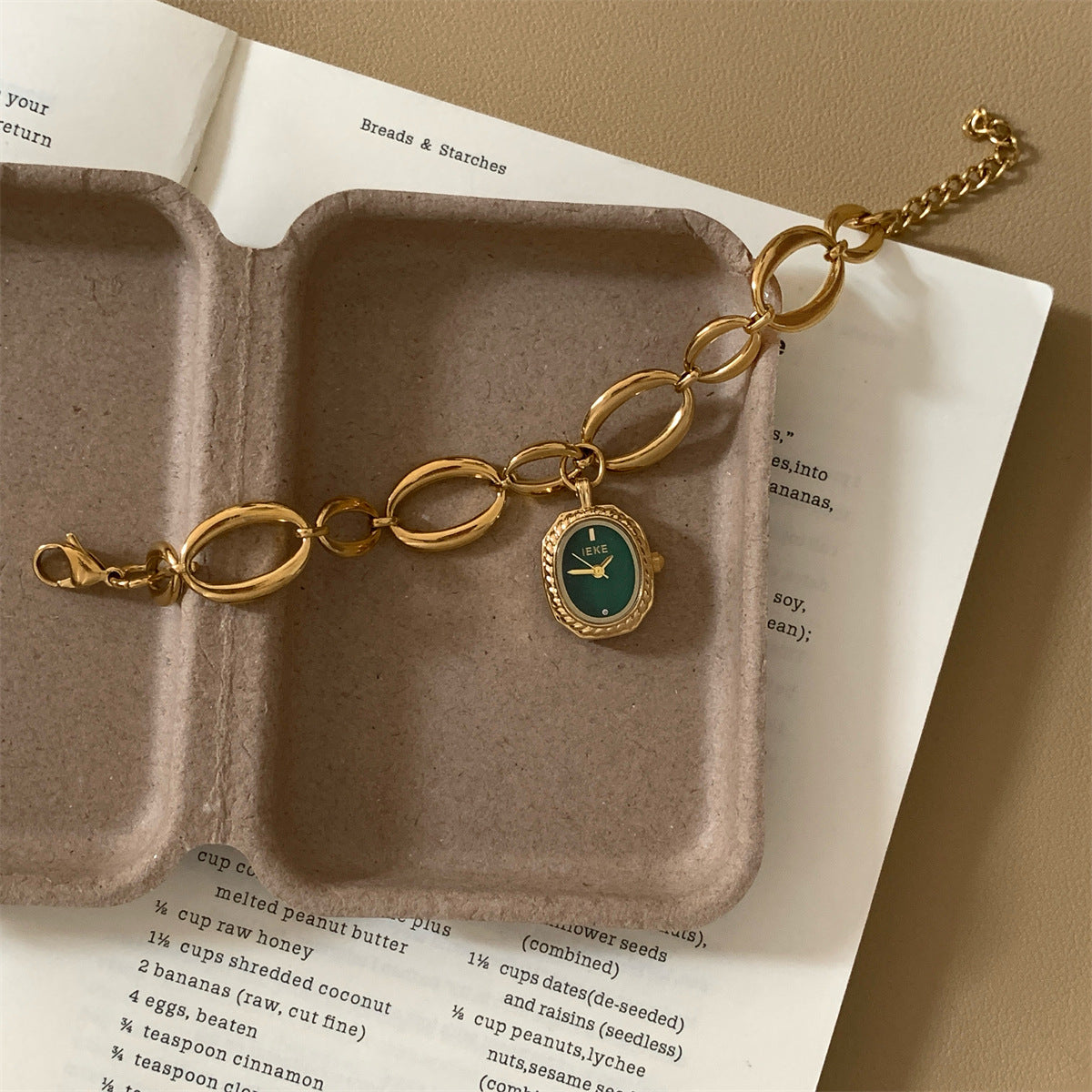 IEKE gold-tone oval-link bracelet watch with green dial