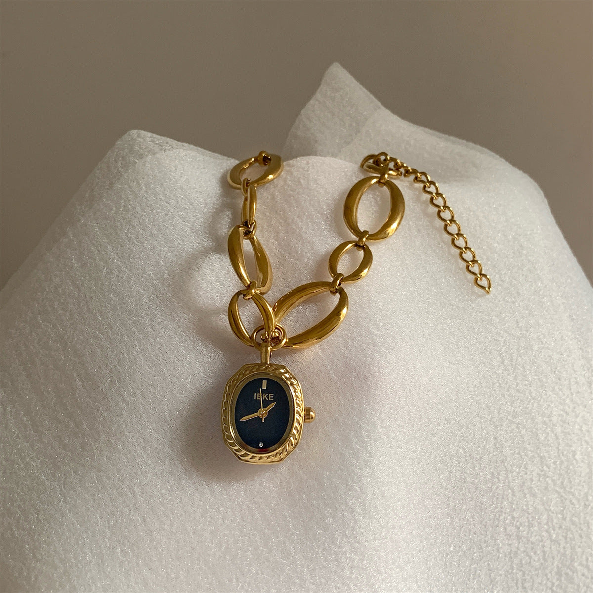 IEKE gold-tone oval-link bracelet watch with navy dial