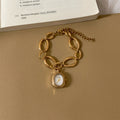 IEKE gold-tone oval-link bracelet watch with white dial